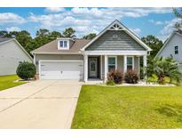Charming single-story home boasts a well-manicured lawn, attached garage and inviting front porch at 109 Astoria Park Loop, Conway, SC 29526