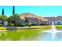 Stunning brick home features a pond with fountain, a well-manicured lawn, and ample outdoor space at 1624 Portwest Dr., Myrtle Beach, SC 29579
