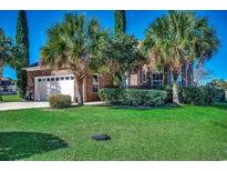 Charming brick home featuring a manicured lawn, mature landscaping, and attached two-car garage at 1624 Portwest Dr., Myrtle Beach, SC 29579