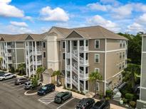 Beautiful low-rise condo building with multiple units, exterior staircases, and a parking lot at 181 Ella Kinley Circle # 305, Myrtle Beach, NY 29588