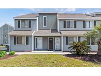 Charming townhome featuring a well-maintained lawn and inviting front entrances at 1890 Colony Dr. # 17T, Surfside Beach, SC 29575
