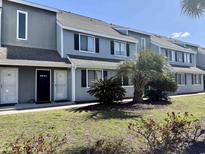 Inviting exterior of a gray townhome with a well-maintained lawn and trimmed bushes at 1890 Colony Dr. # 17T, Surfside Beach, SC 29575