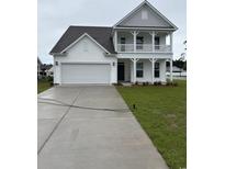 Charming two-story home featuring a welcoming front porch, a two car garage and manicured lawn at 2520 Brescia St., Myrtle Beach, SC 29579