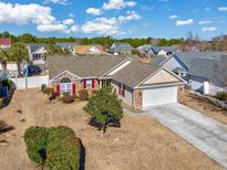 Inviting single-story home with red shutters and a well-manicured lawn at 2623 Corn Pile Rd., Myrtle Beach, SC 29588