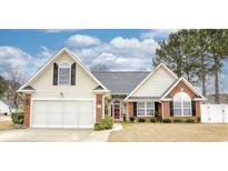 Charming home featuring a manicured lawn, brick accents, and an attached two-car garage at 3736 Brookhill Dr., Myrtle Beach, SC 29588