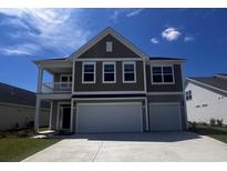 Inviting two-story home with a spacious two-car garage and a charming covered porch at 4043 Bucolic Loop, Myrtle Beach, SC 29588
