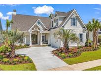 Stunning exterior showcasing manicured lawn, palm trees, flower beds, and a beautiful two-story home at 410 44Th Ave. N, Myrtle Beach, SC 29577