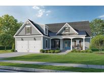 Charming two-story home featuring a covered front porch, blue front door and a two-car garage at 410 44Th Ave. N, Myrtle Beach, SC 29577
