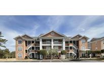 Attractive condo building with multi-level balconies, neutral siding, and well-kept landscaping at 4633 Lightkeepers Way # 5K, Little River, SC 29566