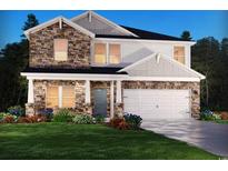 Charming two-story home featuring a stone facade, attached two-car garage, and professionally landscaped front yard at 5036 Riverton Ct, Myrtle Beach, SC 29579