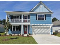 Charming two-story blue home with a spacious two-car garage and landscaped front yard under a clear blue sky at 518 Haven View Way, Murrells Inlet, SC 29576