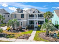 Charming two-story home with a welcoming front porch and well-manicured landscaping at 5220 Mount Pleasant Dr., Myrtle Beach, SC 29579
