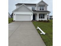Charming two-story home featuring a two-car garage, and a welcoming front porch at 5430 Shelly Lynn Dr., Myrtle Beach, SC 29579