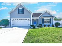 Charming home with blue siding, a well-manicured lawn, and an attached two-car garage at 544 Fox Chase Dr., Conway, SC 29527