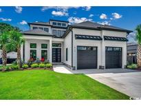 Modern two-story home with a manicured lawn, dark framed windows and two-car garage at 5515 Porcher Ave., Myrtle Beach, SC 29577