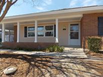 Inviting entrance with covered porch and brick accents at 633 Redwood Ave. # 1, Myrtle Beach, SC 29577