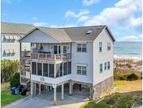 Charming coastal home with a spacious balcony overlooking the ocean at 665 Springs Ave., Pawleys Island, SC 29585