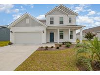 Charming two-story home featuring a welcoming front porch and a well-maintained lawn at 816 Wailea Circle, Little River, SC 29566