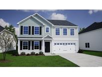 Charming two-story home with gray siding, a two-car garage, and a well-manicured lawn at 903 Agostino Dr., Myrtle Beach, SC 29579