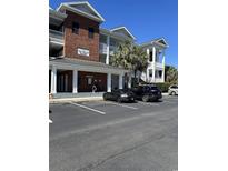 Inviting condo building featuring covered parking, well-maintained landscaping, and classic architectural details at 1001 Ray Costin Way # 1605, Murrells Inlet, SC 29576