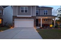 Charming two-story home with a two-car garage and beautifully landscaped front yard at 1330 Reflection Pond Dr., Little River, SC 29566