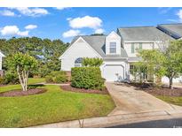 Charming two-story townhome with manicured lawn and an attached one-car garage at 182 Wimbledon Way # 182, Murrells Inlet, SC 29576