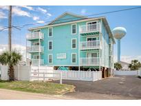 Turquoise condo with three stories, white railings, palm tree, and asphalt drive on a clear day with a blue sky at 212 58Th Ave. N # 1C, North Myrtle Beach, SC 29582
