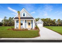 Charming coastal-style home with blue siding, a yellow door, and a well-manicured front yard at 2521 Rowyn St., Longs, SC 29568