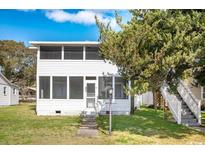 Charming two-story home with a screened porch and lovely landscaping at 2602 Perrin Dr., North Myrtle Beach, SC 29582