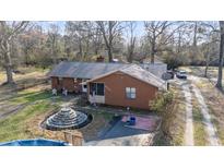 Charming brick home featuring a manicured lawn and unique water feature in the front yard at 2945 Old Railroad Rd., Conway, SC 29527