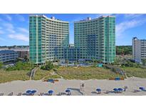 Beautiful beachside condo complex with manicured dunes and ocean views under clear blue skies at 300 N Ocean Blvd. # 1026, North Myrtle Beach, SC 29582