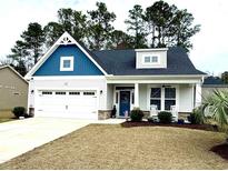 Charming single Gathering home with a blue gable, white siding, and two-car garage at 378 Dunbarton Ln., Conway, SC 29526