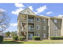 Charming condo building featuring multiple levels with private balconies and well-maintained landscaping at 380 Myrtle Greens Dr. # E, Conway, SC 29526