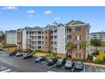 Beautiful condo complex featuring brick accents, multiple balconies, and ample parking at 4875 Luster Leaf Circle # 202, Myrtle Beach, SC 29577