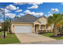 Charming single-story home showcasing a well-manicured lawn, driveway, and an attached two-car garage at 518 Heartland Ct., Murrells Inlet, SC 29576