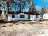 Charming single-story home with a fresh white exterior and a well-maintained yard in a lovely neighborhood at 530 Yarboro St., Mullins, SC 29574