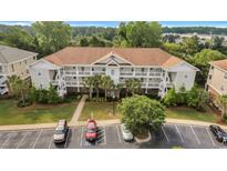 Beautiful condo complex featuring private balconies, a courtyard, and ample parking at 5801 Oyster Catcher Dr. # 1614, North Myrtle Beach, SC 29582