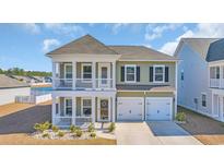 Charming two-story home featuring double porches and a two-car garage with lovely landscaping in a pleasant neighborhood at 738 Harrison Mill St., Myrtle Beach, SC 29579