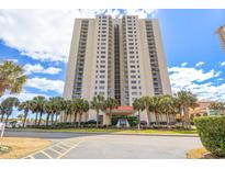 High-rise condo building boasts lush landscaping with tropical palm trees along a scenic road near the beach at 8560 Queensway Blvd. # 1206, Myrtle Beach, SC 29572