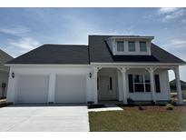 Charming home featuring a two-car garage, covered front porch, and a clean, modern facade at 1071 Laconic Dr., Myrtle Beach, SC 29588