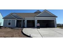 Charming single-story home with a two-car garage and well-manicured front yard at 1105 Oxeye St., North Myrtle Beach, SC 29582