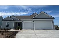 Charming single-story home with gray siding, two-car garage, and well-manicured landscaping at 1105 Oxeye St., North Myrtle Beach, SC 29582