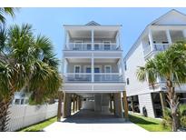 Stunning three-story beach house with covered parking and dual balconies providing ocean views at 113-B 10Th Ave. S, Surfside Beach, SC 29575