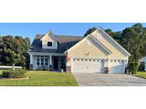 Charming home with a two-car garage, well-kept lawn, and an inviting front porch at 1201 Ficus Dr., Myrtle Beach, SC 29579