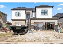 Front exterior view of a home in progress with a white facade, black windows, and construction materials at 1217 Bentcreek Ln., Myrtle Beach, SC 29579
