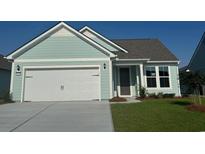 Charming single-Gathering home features a 2 car garage, well-manicured lawn, and a light blue exterior at 1249 Crested Iris Way, North Myrtle Beach, SC 29582