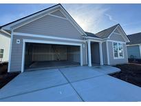 Spacious two car garage with concrete driveway for easy parking at 1253 Crested Iris Way, North Myrtle Beach, SC 29582