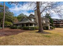 Charming two-story home with a stone chimney, lush landscaping and mature shade trees at 141 Hartland Dr. # 5-C, Myrtle Beach, SC 29572