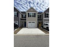Charming townhomes feature neutral siding, black shutters, and driveways for easy parking at 157 B Villa Grande St. # B, Myrtle Beach, SC 29579