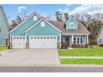 Charming single Gathering home with a three car garage, pristine landscaping, and a cozy front porch at 2418 Goldfinch Dr., Myrtle Beach, SC 29577